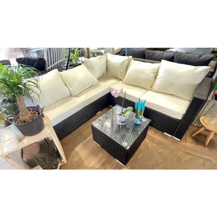 black rattan sofa with cream cushions